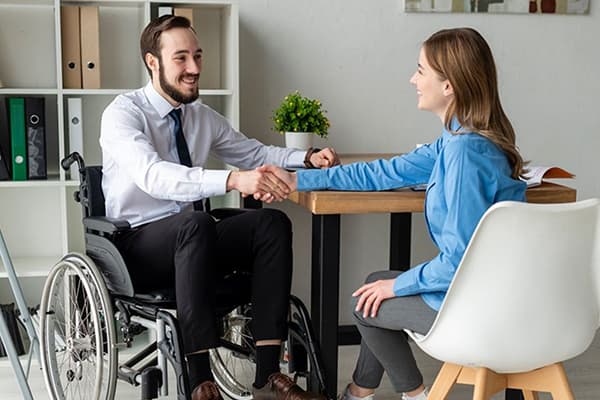 A participant learning job-specific skills alongside a supervisor