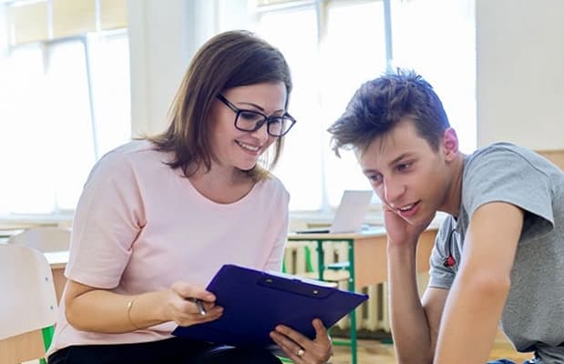 A peer mentor in conversation with a young participant
